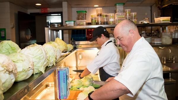  Chef Linton Hopkins and son Linton Hopkins Jr. chop cabbage for sauerkraut at Restaurant Eugene./Photo by Mia Yakel