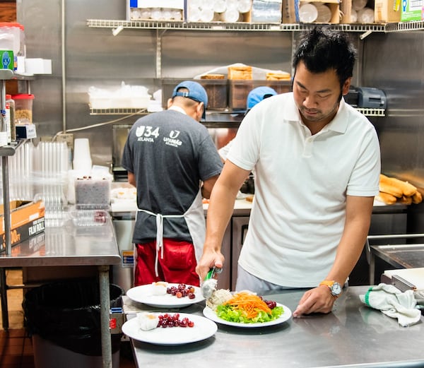 Cafe at Pharr owner Johnny Liu scoops chicken salad in the kitchen of his Buckhead Commons location. CONTRIBUTED BY HENRI HOLLIS