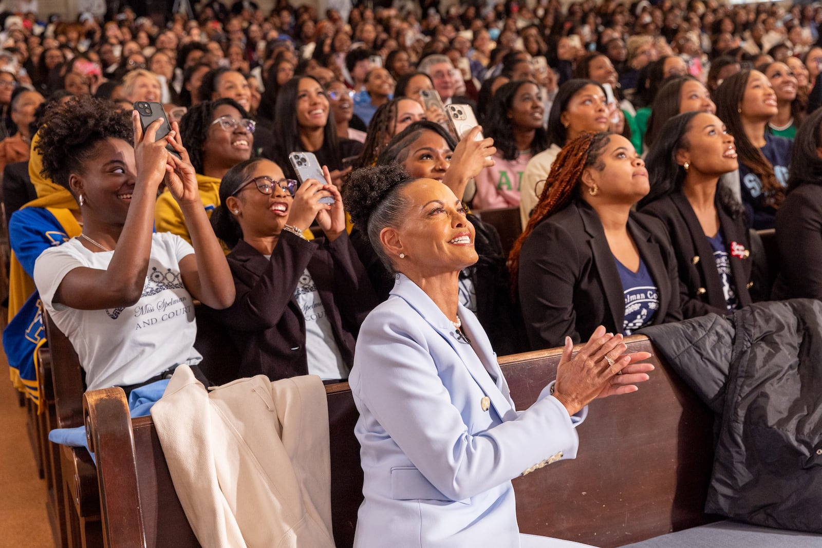 Spelman Board Chair Lovette Russell (center) and students watch a replay of CBS Morning, which aired Russell’s announcement of a $100 million gift at Spelman College in Atlanta on Thursday, January 18, 2024.  (Arvin Temkar/AJC)