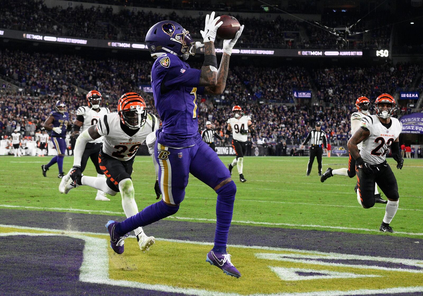 Baltimore Ravens wide receiver Rashod Bateman (7) catches a pass for a touchdown past Cincinnati Bengals cornerback Cam Taylor-Britt (29) and safety Geno Stone (22) during the second half of an NFL football game, Thursday, Nov. 7, 2024, in Baltimore. (AP Photo/Nick Wass)