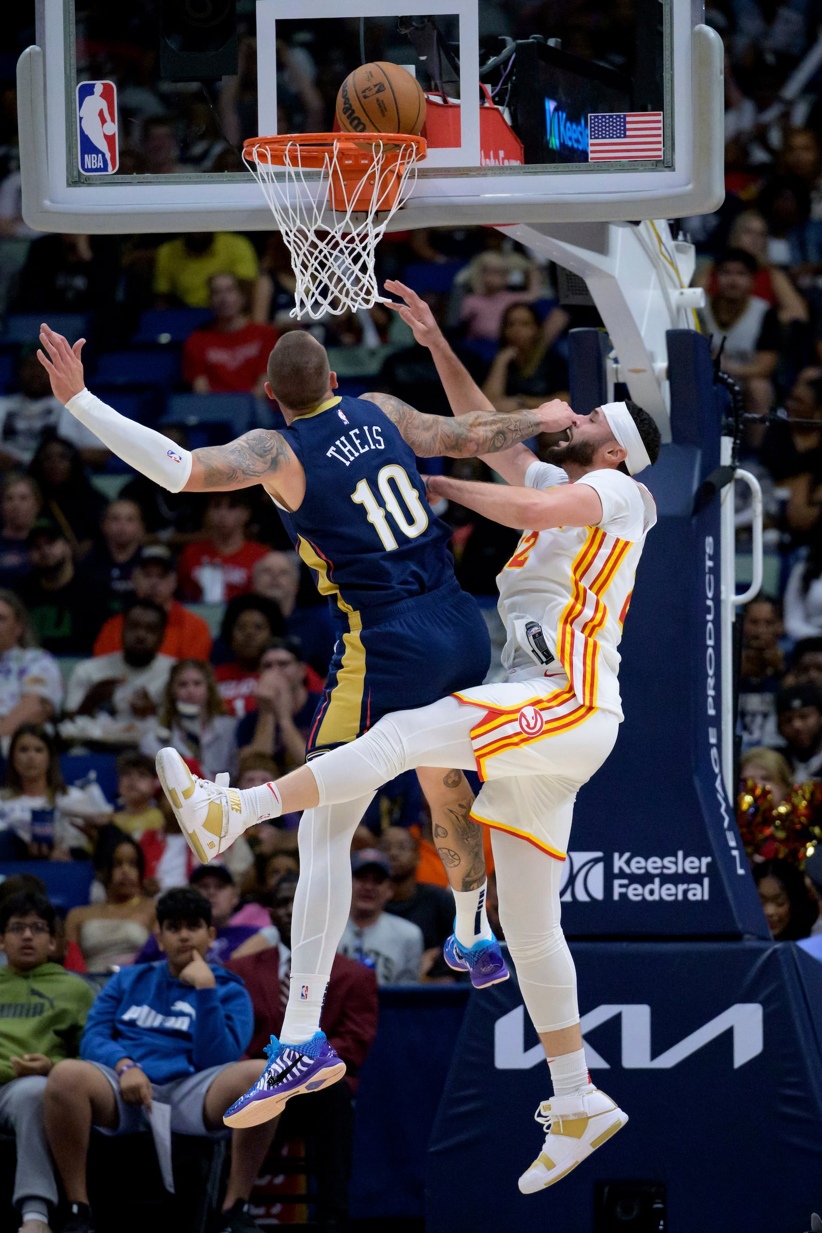 New Orleans Pelicans center Daniel Theis (10) tries to block Atlanta Hawks forward Larry Nance Jr, right, but the ball falls into the basket during the first half of an NBA basketball game in New Orleans, Sunday, Nov. 3, 2024. (AP Photo/Matthew Hinton)