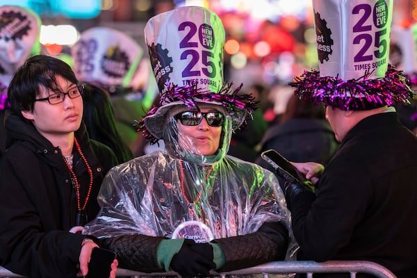 Revellers celebrate in New York's Times Square as they attend a New Year's Eve celebration, Tuesday, Dec. 31, 2024, in New York. (AP Photo/Stefan Jeremiah)