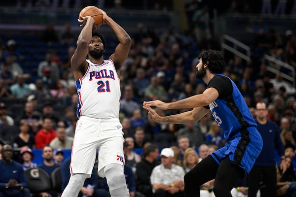 Philadelphia 76ers center Joel Embiid (21) shoots in front of Orlando Magic center Goga Bitadze (35) during the first half of an Emirates NBA Cup basketball game, Friday, Nov. 15, 2024, in Orlando, Fla. (AP Photo/Phelan M. Ebenhack)