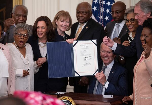 Vice President Kamala Harris, front, second from left, and Opal Lee, front left, the activist known as the grandmother of Juneteenth, watch as President Joe Biden holds the signed Juneteenth National Independence Day Act in the East Room of the White House in 2021.