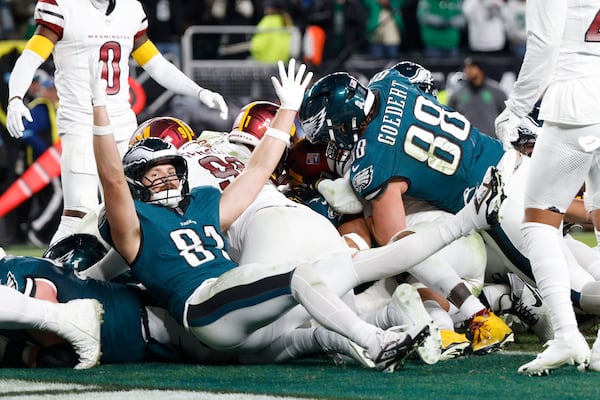 Philadelphia Eagles tight end Grant Calcaterra (81) celebrates a 1-yard touchdown by teammate Jalen Hurts during the second half of an NFL football game against the Washington Commanders Thursday, Nov. 14, 2024, in Philadelphia. (AP Photo/Laurence Kesterson)