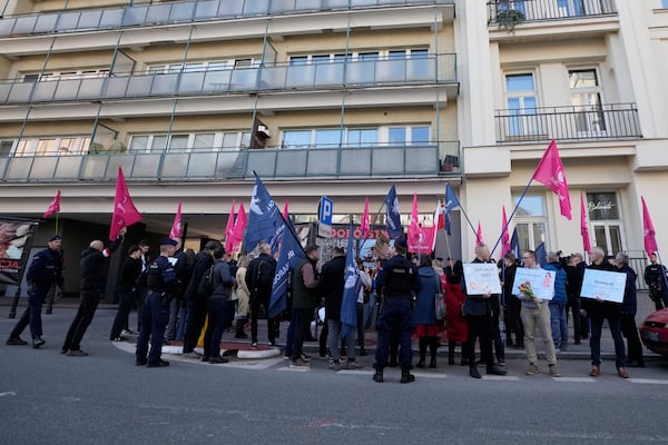 Protesters stand outside the newly opened center where women can go to have abortions with pills, during its inauguration, in Warsaw, Saturday March 8, 2025. (AP Photo/Czarek Sokolowski)