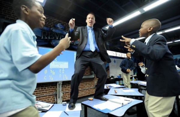 080304 Atlanta, GA: Ron Clark's a very engaging and energetic teacher. He likes to walk on his students' desks and leads them in little songs to help their lesson. Clark spoke at an event a while back and caught the eye of model turned philanthropist Melanie Boltax. The two have teamed up to pull off the first society gala to benefit Ron Clark Academy, which opened in south Atlanta. Ron Clark (center) sings and dances during 5th-grade Pre-Algebra class at the school. Tuesday March 4, 2008. HYOSUB SHIN / AJC 080304 Atlanta, GA: Ron Clark's a very engaging and energetic teacher. He likes to walk on his students' desks and leads them in little songs to help their lesson. Clark spoke at an event a while back and caught the eye of model turned philanthropist Melanie Boltax. The two have teamed up to pull off the first society gala to benefit Ron Clark Academy, which opened in south Atlanta. Ron Clark (center) sings and dances during 5th-grade Pre-Algebra class at the school. Tuesday March 4, 2008. HYOSUB SHIN / AJC