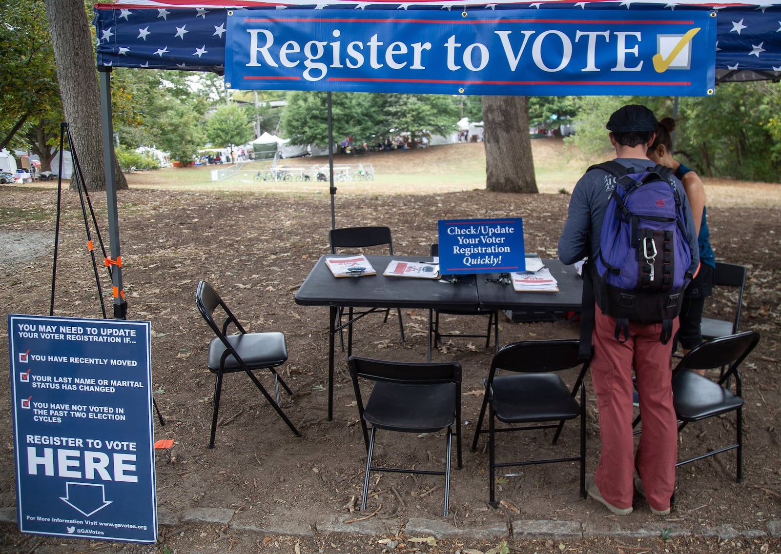 Greg Sawicki checks to make sure his voter registration is in order during the Candler Park Fall Fest 2019 in Atlanta. STEVE SCHAEFER / SPECIAL TO THE AJC