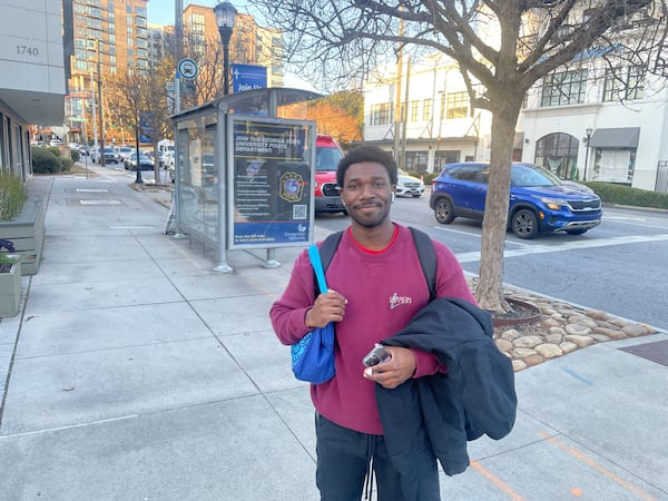 Brad Smith of Atlanta walks from his job at Piedmont Hospital to MARTA’s Arts Center subway stop via the Peachtree Street North Bridge spanning I-85. (Michael Scaturro/AJC)