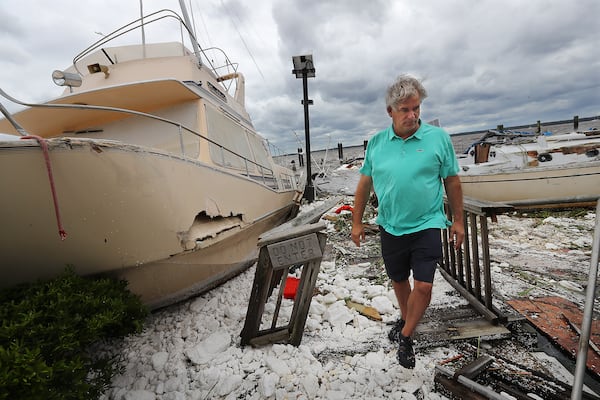 September 11, 2017 St. Marys: Local resident Jay Lassiter takes in the remains of a pile of boats, many under the water that canât be seen, after they were swept together and sank when their docks were destroyed as Hurricane Irma swept through the area on Monday, September 11, 2017, in St. Marys.    Curtis Compton/ccompton@ajc.com