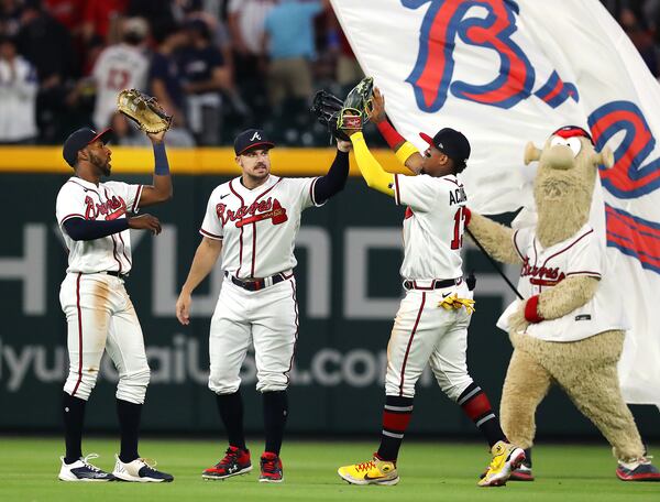 Braves outfielders Travis Demeritte (left), Adam Duvall (second from left), and Ronald Acuna celebrate with mascot Blooper after the 5-1 victory over the Chicago Cubs.   “Curtis Compton / Curtis.Compton@ajc.com”