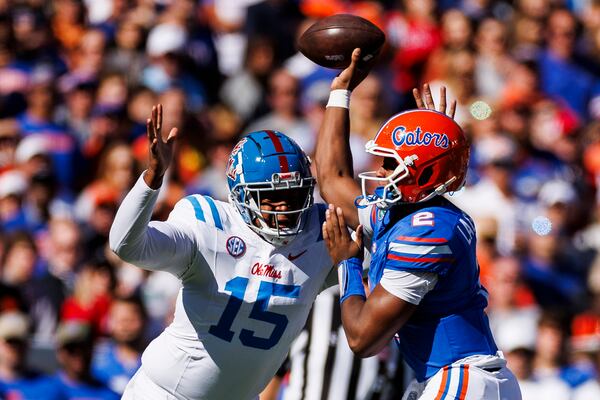 Florida's DJ Lagway (2) throws a pass under pressure from Ole Miss' Jared Ivey (15) during the first half at Ben Hill Griffin Stadium on Saturday, Nov. 23, 2024, in Gainesville, Florida. (James Gilbert/Getty Images/TNS)