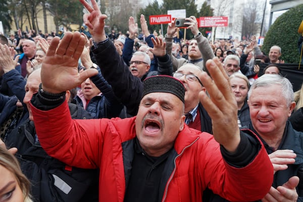 Supporters of Bosnian Serb President Milorad react after a court sentenced him to one year in prison and banned him from engaging in politics for six years over his separatist actions, during a rally in the Bosnian town of Banja Luka, 240 kms northwest of Sarajevo, Wednesday, Feb. 26, 2025. (AP Photo/Radivoje Pavicic)