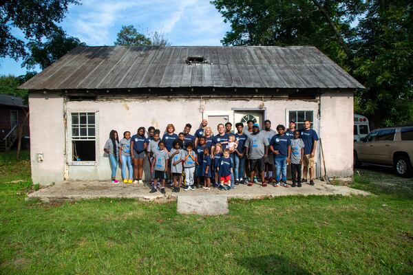 Pastor Terrell Scott, his family and volunteers with the Malachi Project will turn this home into a community center. PHIL SKINNER/ FOR THE AJC