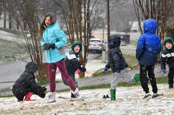 January 16, 2022 Lawrenceville - Maddy Nobles (left), 11, and other kids in neighborhood have a snowball fight as the snow falls in Lawrenceville on Sunday, January 16, 2022. Snowfall continues to move south of I-285 and south Fulton and Coweta counties could see up to 2 inches of snow by Sunday evening. Major impacts near Lake Lanier and into the North Georgia mountains are being felt and certain spots could see up to 10 inches of snow. As of around noon, snow is moving through Troup and Coweta counties, as Fayette and Clayton counties still patiently wait for some flurries amidst the rain and some wintry mix. (Hyosub Shin / Hyosub.Shin@ajc.com)