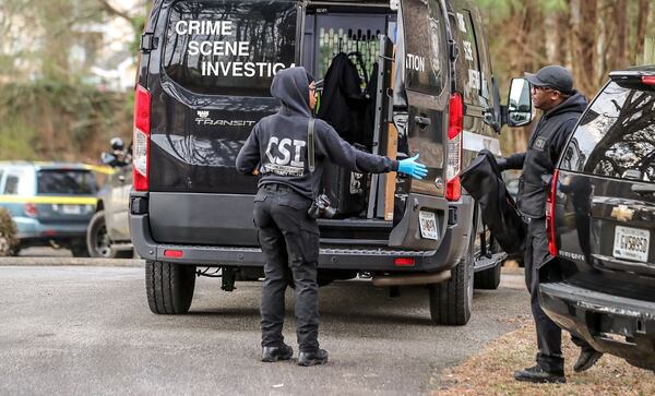 Crime scene investigators examine the scene of a shooting Tuesday morning at a DeKalb County apartment complex.