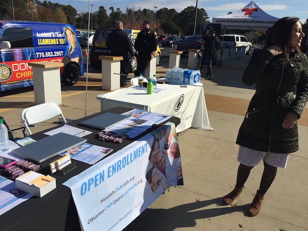 Viviana Cossio stands beside the information table she set up in Lilburn to draw people to inquire about enrolling in health care plans under Obamacare in November. (PHOTO by Ariel Hart/AJC)