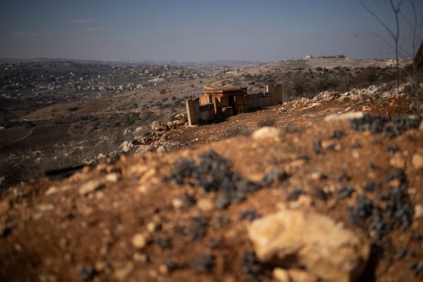 Backdropped by a Lebanese village an Israeli army position sits near the Israeli-Lebanese border, during the ceasefire between Israel and Hezbollah, as seen from the northern Israel, Saturday, Nov. 30, 2024. (AP Photo/Leo Correa)