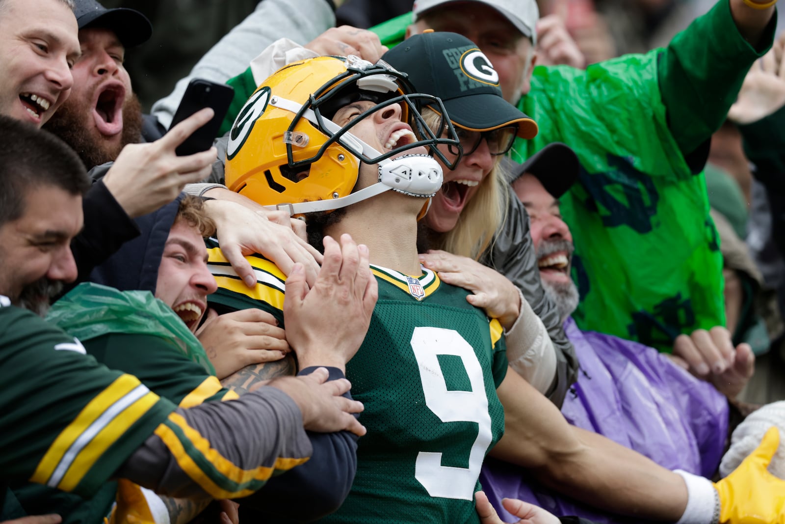 Green Bay Packers wide receiver Christian Watson celebrates his 44-yard reception for a touchdown with fans during the first half of an NFL football game against the Arizona Cardinals, Sunday, Oct. 13, 2024, in Green Bay. (AP Photo/Matt Ludtke)