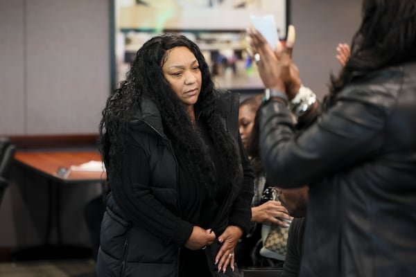 Members of the public stand after Monique Ramos, the wife of the late Leroy Ramos, spoke during a public comment portion of the board of directors meeting at MARTA headquarters on Thursday, Jan. 9, 2025, in Atlanta. (Jason Getz/AJC)
