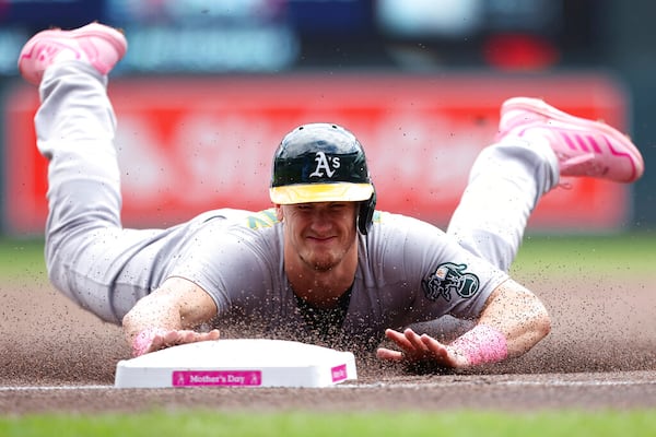 Oakland Athletics' Sean Murphy (12) steals third base on a wild pitch by Minnesota Twins starting pitcher Chris Paddack (20) during the first inning of a baseball game Sunday, May 8, 2022, in Minneapolis. (AP Photo/Stacy Bengs)