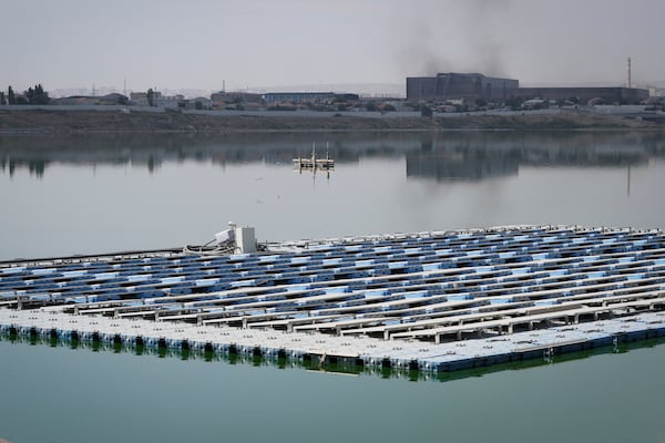 Solar panels float outside the Olympic Stadium, in Baku, Azerbaijan, Monday, Sept. 16, 2024. (AP Photo/Sergei Grits)