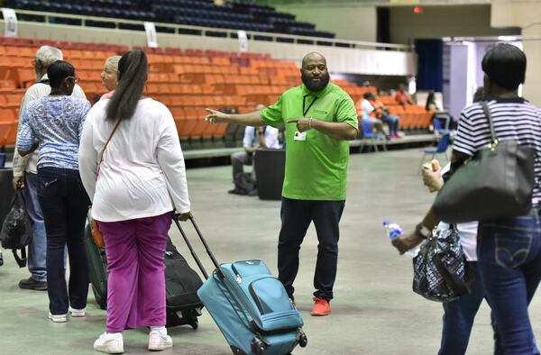 September 3, 2019 Savannah - Kareem Hill (center) with Savannah Human Services directs local residents inside the Savannah Civic Center before they get a free transportation to inland shelters under mandatory evacuation ahead of Hurricane Dorian on Tuesday, September 3, 2019. Chatham Area Transit (CAT) provided free transportation to residents without private transportation to the Savannah Civic Center to assist in the mandatory evacuation of Chatham County. (Hyosub Shin / Hyosub.Shin@ajc.com)