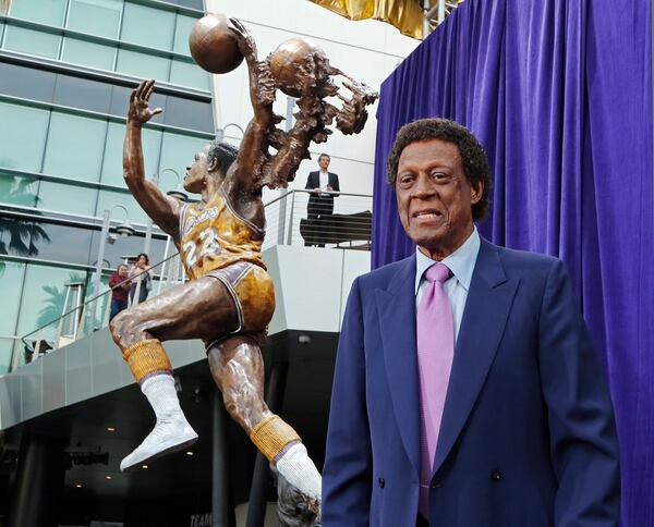 Elgin Baylor stands next to a statue, just unveiled, honoring the Minneapolis and Los Angeles Lakers great, outside Staples Center in Los Angeles on Friday, April 6, 2018. (Reed Saxon/AP)