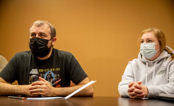 Koie Smith, left, and his wife Jennifer Smith, right, speak to a reporter at AbsoluteCare on Peachtree Street on Thursday, Oct 21, 2021.  Koie contracted COVID-19 in March and has ongoing problems with neurological processing, sleeping, smelling and taste. He recently  decided to take medical leave from his executive leadership IT position to focus on his therapy in the hope that he can regain function.  (Jenni Girtman for The Atlanta  Journal-Constitution