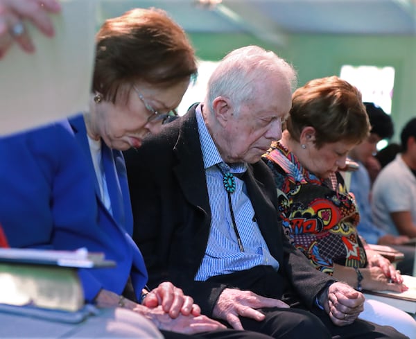 Former President Jimmy Carter and former first lady Rosalynn Carter bow their heads in prayer along with members and visitors during the worship service at Maranatha Baptist Church in Plains on Sunday, June 9, 2019, in Plains.  (Photo: Curtis Compton/ccompton@ajc.com)