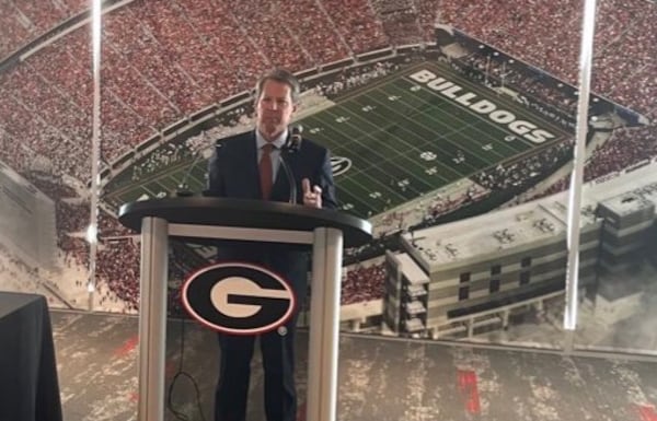 Georgia Gov. Brian Kemp speaks to a small gathering in the recruiting lounge at Sanford Stadium in Athens on May 6, 2021, before signing into law House Bill 617, giving college athletes in the state the right to make money off their name, image or likeness. (Photo by Greg Bluestein/AJC)