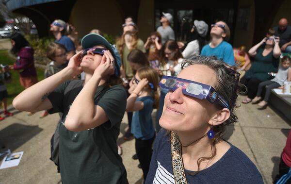 Amy Rico and Rachel Beckmann watch the eclipse at the Northgate branch of the Chattanooga Public Library on Monday. (Photo Courtesy of Matt Hamilton)