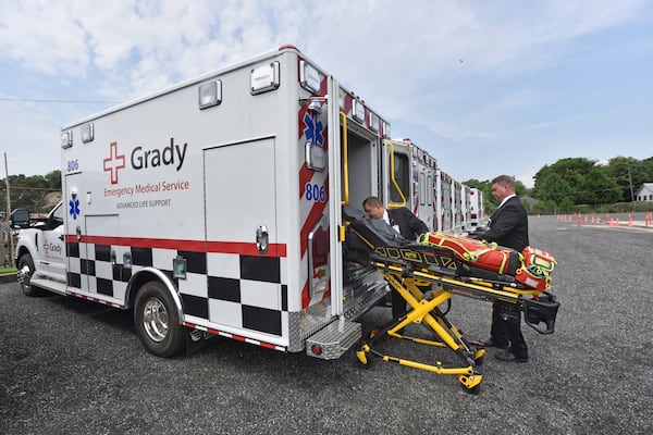 Steven Moyers (left), Vice President of Grady EMS Education Academy, and Paul Beamon, Director of EMS Operations, show off one of 10 new EMS Vehicles in a parking lot of Grady EMS. Grady EMS planned to take over ambulance service Sept. 1, but must move faster after American Medical Response said it would be leaving the zone beginning at the end of June. HYOSUB SHIN / HSHIN@AJC.COM