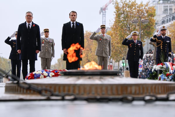 French President Emmanuel Macron, center, and Britain's Prime Minister Keir Starmer stand at attention at the Tomb of the Unknown Soldier during commemorations marking the 106th anniversary of the November 11, 1918, Armistice, ending World War I, in Paris, Monday, Nov. 11, 2024. ( Ludovic Marin, Pool via AP)