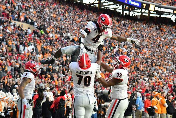 Georgia's running back James Cook (4) celebrates with teammates after scoring a touchdown in the first half during a NCAA football game at Neyland Stadium in Knoxville on Saturday, November 13, 2021. (Hyosub Shin / Hyosub.Shin@ajc.com)