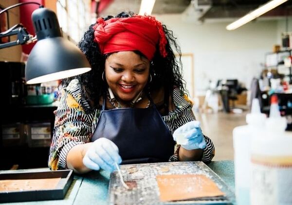 Azzie Caldwell and other employees at Rebel Nell learn the art of jewelry making. Fans have a piece of history. Items that would otherwise be discarded are put to good use. And disadvantaged women are uplifted and empowered, says CEO Amy Peterson. Courtesy of Rebel Nell