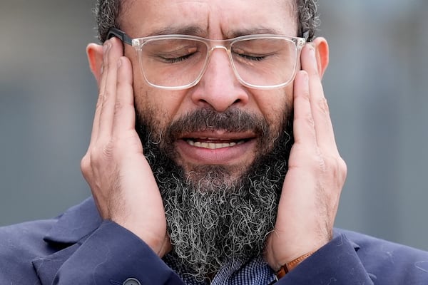 Mohamed Radwan, Outreach Coordinator of Council on American-Islamic Relations members, prays outside outside the Will County Courthouse where a jury found defendant Joseph Czuba found guilty of murder and hate crime charges, Friday, Feb. 28, 2025, in Joliet, Ill. (AP Photo/Nam Y. Huh)