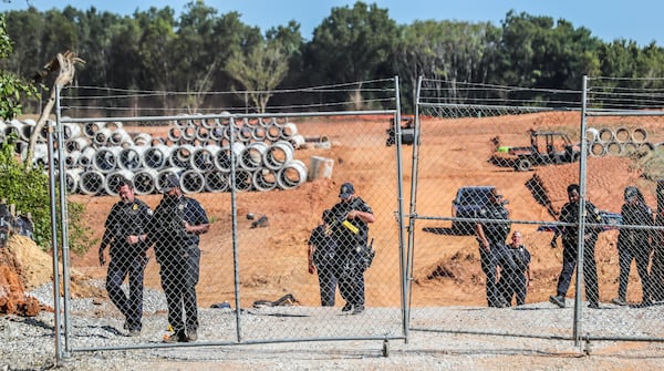 September 7, 2023 DeKalb County: Protesters gathered on Constitution Road (shown here) after five individuals were arrested Thursday morning, Sept. 7, 2023 at the site of Atlanta’s proposed public safety training center after chaining themselves to construction equipment in an effort to halt work. According to the Atlanta Police Department, the training center opponents broke into the construction site off Constitution Road around 9:30 a.m. Thursday. “Those 5 people have been taken into custody and we are working with the Georgia Bureau of Investigation regarding charges on these individuals,” the department said in a statement. About two dozen protesters also lined the site in unincorporated DeKalb County, east of Atlanta, in opposition to the 85-acre facility. They chanted “Cop City will never be built” as law enforcement officers amassed. The crowd called the effort “the people’s injunction” to halt construction. “We have tried to get justice in the courts, we have tried to get justice using our politicians, and unfortunately, they have betrayed and failed us,” said Mary Hooks, with the activist group Movement for Black Lives. “So when our government systems fail, that is when the people must stand up and take action.” The demonstration comes just days after more than 60 anti-training center activists were indicted on racketeering and other charges over the ongoing clash between the city and facility opponents. The indictment mainly focuses on the Defend the Atlanta Forest group, with prosecutors describing it as an “anti-government, anti-police, and anti-corporate extremist organization.” The indictment, handed up by a Fulton County grand jury, is being prosecuted by the Georgia Attorney General’s Office. “Anytime somebody puts their bodies on the line for the cause,” said Hooks, “it was worth the risk.” (John Spink / John.Spink@ajc.com)

