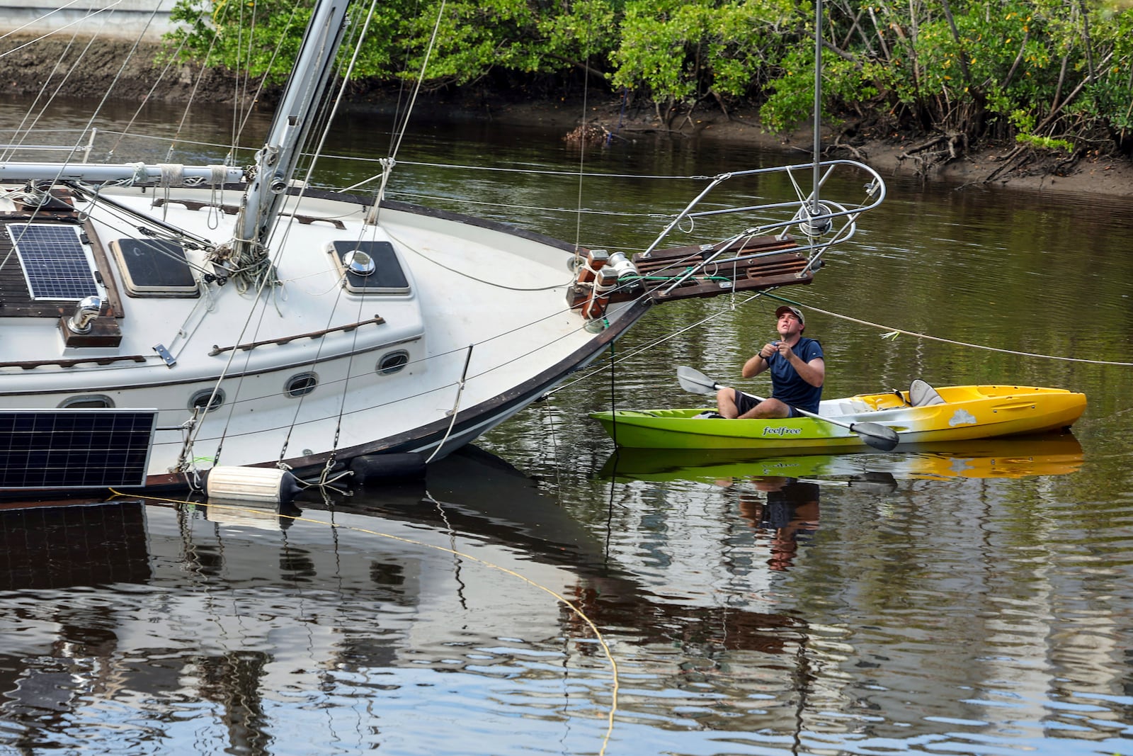 Tyler Griffin secures his boat in preparation for Hurricane Milton on Tuesday, Oct. 8, 2024, in New Port Richey, Fla. (AP Photo/Mike Carlson)