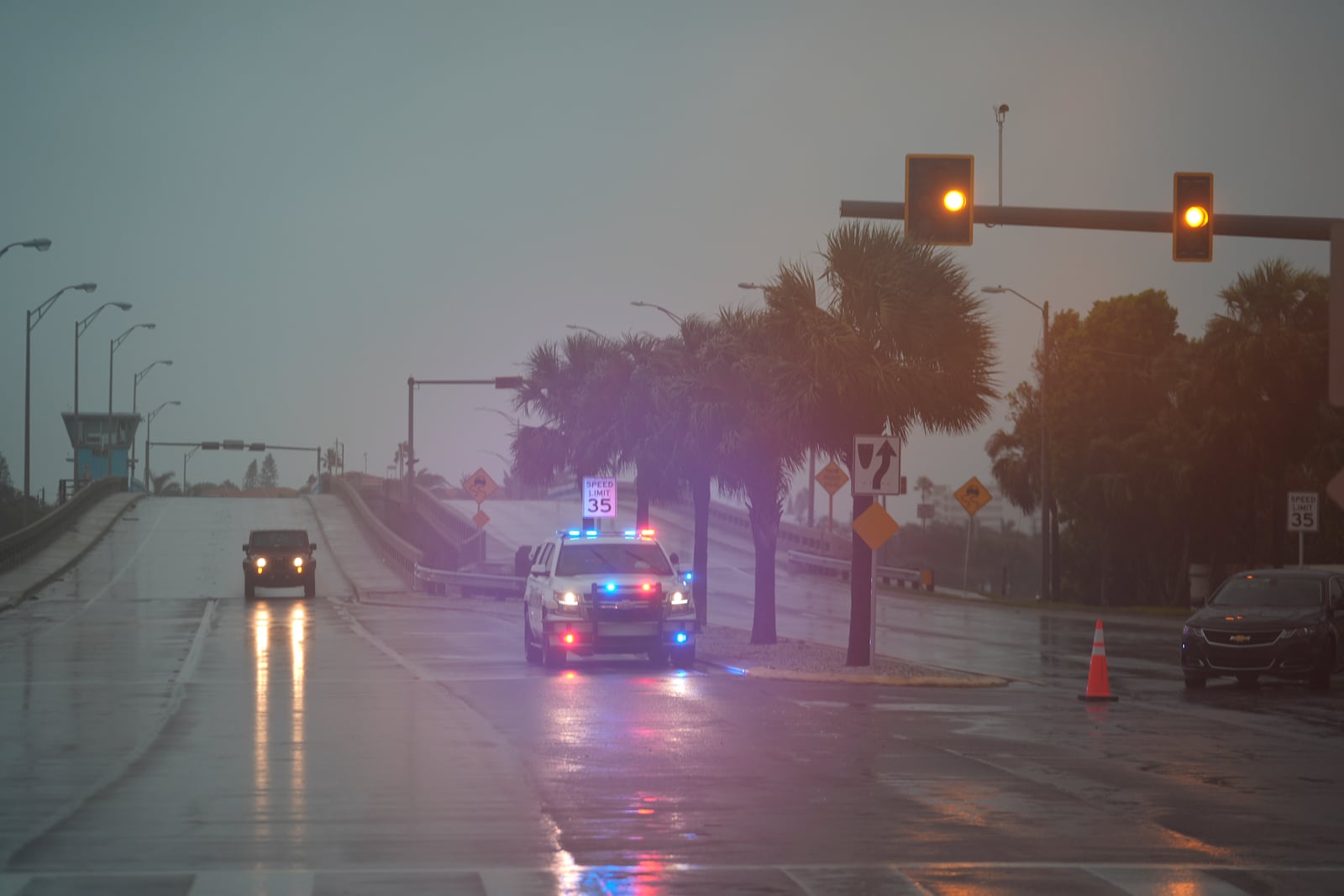 Police block off a bridge leading to the barrier island of St. Pete Beach, Fla., ahead of the arrival of Hurricane Milton, in South Pasadena, Fla., Wednesday, Oct. 9, 2024. (AP Photo/Rebecca Blackwell)