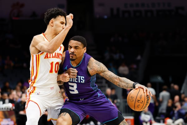 Charlotte Hornets guard DaQuan Jeffries (3) drives into Atlanta Hawks forward Zaccharie Risacher during the first half of an NBA basketball game in Charlotte, N.C., Tuesday, March 18, 2025. (AP Photo/Nell Redmond)