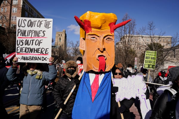 Protestors rally on Inauguration Day, Monday, Jan. 20, 2025, in Washington. (AP Photo/Jose Luis Magana)