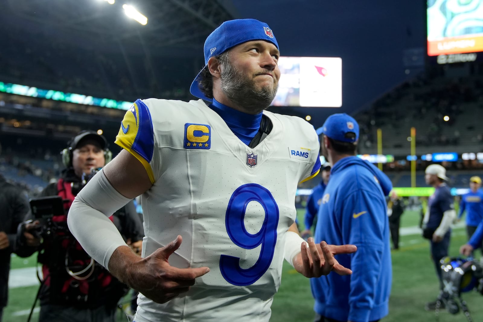 Los Angeles Rams quarterback Matthew Stafford (9) runs off the field after the Rams defeated the Seattle Seahawks in overtime of an NFL football game in Seattle, Sunday, Nov. 3, 2024. (AP Photo/Stephen Brashear)