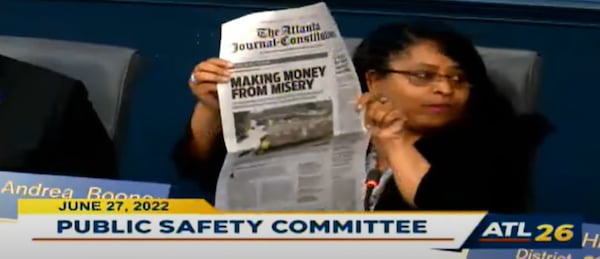 Councilwoman Andrea Boone, whose district covers much of southwest Atlanta, holds up a copy of the AJC's June 15 newspaper that features part of the Dangerous Dwellings investigation.