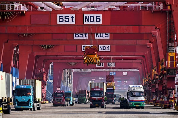 FILE - In this photo released by Xinhua News Agency, containers are unloaded from a cargo ship at Qingdao Port, east China's Shandong Province on Feb.11, 2024. (Li Ziheng/Xinhua via AP, File)