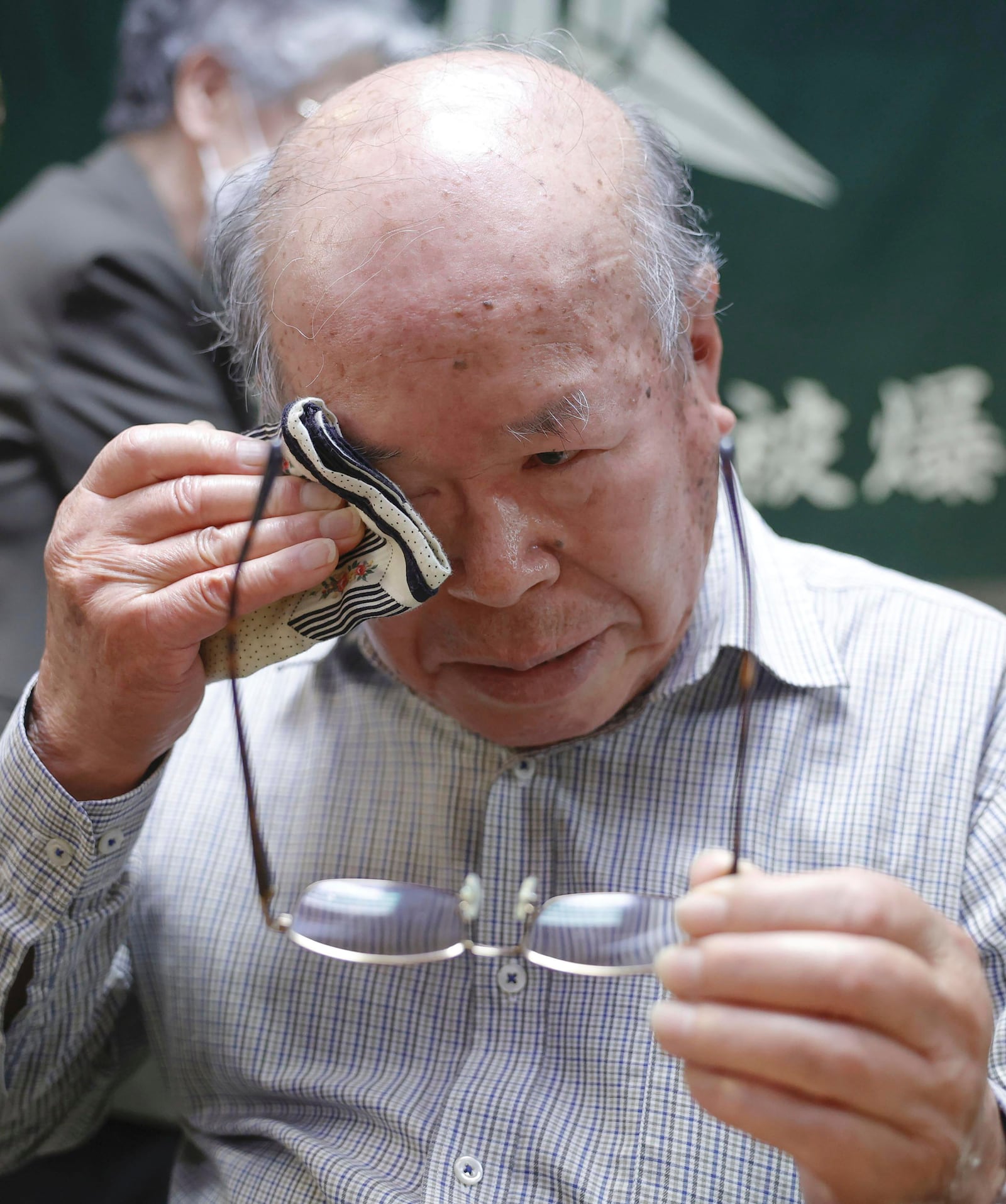 Shigemitsu Tanaka, the chairman of Nagasaki Atomic bomb Survivors Council, cries during a press conference, in Nagasaki, western Japan, Friday, Oct. 11, 2024, after Nihon Hidankyo, or the Japan Confederation of A- and H-Bomb Sufferers Organizations, won the Nobel Peace Prize.(Kyodo News via AP)