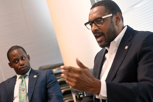 State Rep. Vernon Jones (right) speaks during the DeKalb Board of Ethics meeting Tuesday as Demetrius McCoy (left), chief of staff for DeKalb Commissioner Mereda Davis Johnson, listens. (Rebecca Breyer)