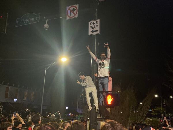 Georgia fans make use of public infrastructure to celebrate the first Bulldogs national championship in 41 years. (Holland Mowry/Special to The AJC)