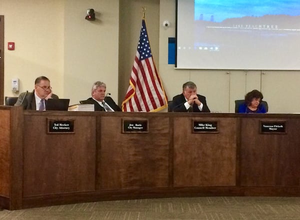 Glum Peachtree City officials listen to more than 30 residents express opposition to a plan aimed at fighting “defamation.” From left, City Attorney Ted Meeker, City Manager Jon Rorie, Councilman Mike King, Mayor Vanessa Fleisch.