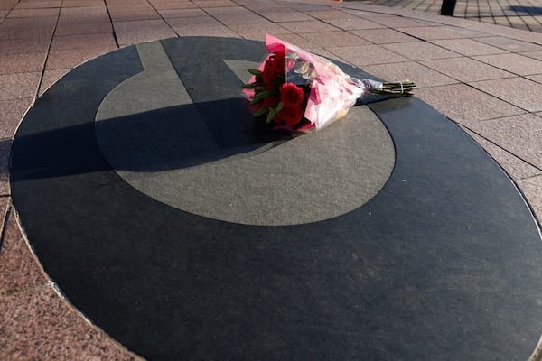 A lone bouquet of flowers rests outside the Butts-Mehre Football complex in memory of University of Georgia  football player Devin Willock and football staff member Chandler LeCroy who died in a car accident on Sunday, January 15, 2023.  (Natrice Miller/natrice.miller@ajc.com) 